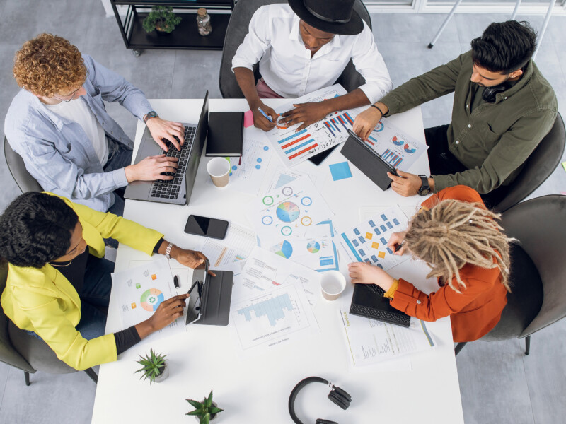 coworkers sitting around a table working together