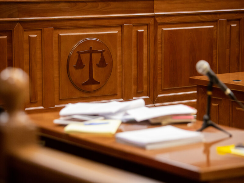 Courtroom interior with scales of justice in focus