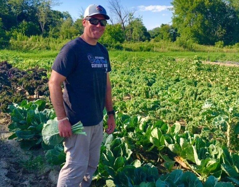 Gravel & Shea team member volunteering in community garden gleaning program