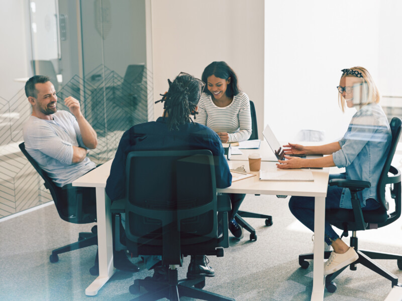 employees sitting at a table having a meeting